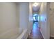 Hallway leading to bedrooms and a bathroom featuring hard wood flooring at 169 Vista View Ave, Eagle Lake, FL 33839