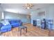 Cozy second-floor living room with a blue sofa and modern ceiling fan at 169 Vista View Ave, Eagle Lake, FL 33839