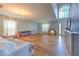 Bright living room featuring an open floor plan, wood floors, and a large window for natural light at 169 Vista View Ave, Eagle Lake, FL 33839