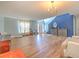 Bright living room featuring hardwood floors, high ceilings, and a decorative chandelier at 169 Vista View Ave, Eagle Lake, FL 33839