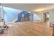 Open concept living room with hardwood floors, featuring blue accent wall and staircase at 169 Vista View Ave, Eagle Lake, FL 33839