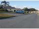 Residential street view with parked truck and houses at 26608 Racquet Cir, Leesburg, FL 34748