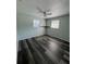 View of the second bedroom featuring a ceiling fan and wood laminate flooring at 1224 10Th St, Holly Hill, FL 32117