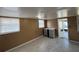 This bonus room has gray cabinets, tile flooring, and a door to the backyard at 1224 10Th St, Holly Hill, FL 32117