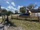 Charming front yard with a new wooden picket fence, palm tree, and grass leading up to the residence at 1224 10Th St, Holly Hill, FL 32117