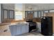 This kitchen features light gray cabinets and black appliances at 1224 10Th St, Holly Hill, FL 32117
