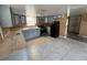 Spacious kitchen with light gray cabinets, tile flooring, and black appliances at 1224 10Th St, Holly Hill, FL 32117