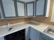 Kitchen with gray cabinets, white countertops and black dishwasher at 1224 10Th St, Holly Hill, FL 32117