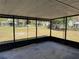 This screened porch overlooks the fenced backyard at 1224 10Th St, Holly Hill, FL 32117