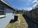Side yard view of house leading to a wooded fence at 1224 10Th St, Holly Hill, FL 32117