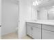 Modern bathroom with double sink vanity, white cabinetry, and chrome fixtures at 4430 Petunia St, Lake Hamilton, FL 33851
