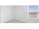 Bedroom with closet and view of the community through a sunny window at 4430 Petunia St, Lake Hamilton, FL 33851