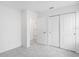 Spacious bedroom with grey carpet, white walls, walk-in closet and doors at 4430 Petunia St, Lake Hamilton, FL 33851