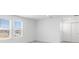 Minimalist bedroom with large windows, a double closet, and neutral-toned carpet at 4430 Petunia St, Lake Hamilton, FL 33851