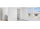 Bright bedroom with large windows, grey carpet, ensuite bathroom, and walk-in closet at 4430 Petunia St, Lake Hamilton, FL 33851