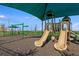 Community playground with slides, swings and shade at 4430 Petunia St, Lake Hamilton, FL 33851