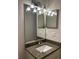 Updated bathroom with modern fixtures, featuring granite countertop, under-mount sink, decorative mirrors and lighting at 17729 Se 114Th Ct, Summerfield, FL 34491
