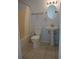 Bathroom featuring a tub and shower combo, pedestal sink, and updated lighting at 17729 Se 114Th Ct, Summerfield, FL 34491