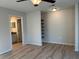 Bright bedroom featuring wood floors, a ceiling fan, recessed lighting, and an adjacent bathroom at 17729 Se 114Th Ct, Summerfield, FL 34491