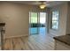 Inviting dining area featuring new flooring, sliding glass doors to outdoor lanai, and bright natural light at 17729 Se 114Th Ct, Summerfield, FL 34491