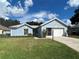 Charming single-story home features a well-manicured lawn, a two-car garage, and a lovely blue exterior at 17729 Se 114Th Ct, Summerfield, FL 34491