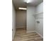 Functional laundry room featuring wood floors and an accessible utility shelf at 17729 Se 114Th Ct, Summerfield, FL 34491