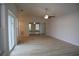 Bright living room boasts light wood flooring, vaulted ceilings and a ceiling fan at 17729 Se 114Th Ct, Summerfield, FL 34491