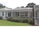 Enclosed patio features a screen and flower garden for relaxing in the Florida sunshine at 17729 Se 114Th Ct, Summerfield, FL 34491