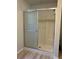 Bathroom shower with sliding glass doors and neutral finishes at 17729 Se 114Th Ct, Summerfield, FL 34491