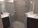 Bathroom with gray tiling, double vanity with white countertop, and a glass walk-in shower with a mosaic base at 1263 Verdant Glade Pl, Winter Park, FL 32792
