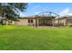 Large backyard with screened patio and lush lawn at 368 Toldedo Rd, Davenport, FL 33837