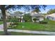 Charming single-story home with well-manicured lawn, festive holiday decorations, and mature landscaping at 1694 Town Park Dr, Port Orange, FL 32129