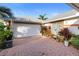 Spacious two-car garage with brick paved driveway and mature landscaping at 1694 Town Park Dr, Port Orange, FL 32129