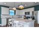 Modern kitchen with white cabinets, quartz countertops, and an island at 427 Pine Tree Blvd, Lake Alfred, FL 33850