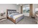 Spacious bedroom with wood bed frame, neutral color palette, and carpeted floors at 4464 Sw 84Th Street Rd, Ocala, FL 34476