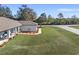 Well-maintained white home with a manicured lawn on a corner lot at 3805 Sw 115Th St, Ocala, FL 34476