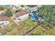 Aerial view of house, backyard pool, shed, and surrounding area at 136 Cory Ct, Auburndale, FL 33823