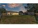 Backyard view of house, shed, and above-ground pool at 136 Cory Ct, Auburndale, FL 33823