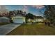 House exterior featuring a two-car garage and landscaping at 136 Cory Ct, Auburndale, FL 33823