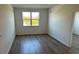 Well-lit bedroom with hardwood floors and large window at 1210 Southstation Pl # 202, Orlando, FL 32809