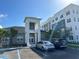 Apartment building exterior with parking and entryway at 1210 Southstation Pl # 202, Orlando, FL 32809