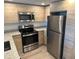 Modern kitchen with stainless steel appliances at 1210 Southstation Pl # 202, Orlando, FL 32809