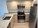 Modern kitchen with stainless steel appliances at 1210 Southstation Pl # 202, Orlando, FL 32809