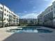 Community pool with surrounding apartment buildings at 1210 Southstation Pi # 202, Orlando, FL 32809