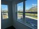 Room with windows showcasing a view of the parking lot and surrounding landscape at 1210 Southstation Pl # 202, Orlando, FL 32809