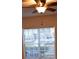 Sunlit bedroom window with a ceiling fan, blinds and view of the neighborhood at 4340 S Kirkman Rd # 905, Orlando, FL 32811