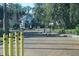 Community gate with wrought iron, two decorative wreaths, and yellow bollards at 4340 S Kirkman Rd # 905, Orlando, FL 32811