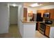 Bright kitchen featuring wooden cabinetry, stainless steel appliances, and granite countertops at 4340 S Kirkman Rd # 905, Orlando, FL 32811