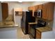 Kitchen features stainless steel appliances, granite countertops, and wooden cabinets at 4340 S Kirkman Rd # 905, Orlando, FL 32811