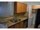 Kitchen features stainless steel appliances, granite countertops, and wooden cabinets at 4340 S Kirkman Rd # 905, Orlando, FL 32811
